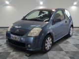a picture of a small blue car parked on a checkered floor