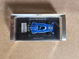 a close up of a blue race car in a clear box