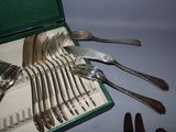 a lot of forks and spoons in a green case