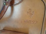 a brown leather bag with a horse on it