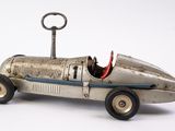 une petite voiture en métal sur laquelle est posée une clé