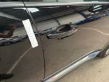a silver car with a sticker on the side of it