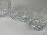 three glasses and a decanter sitting on a table