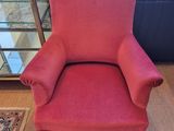 pink chair with pleated seat and foot rest in front of a window