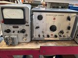 two electronic equipment sitting on top of a table in a room
