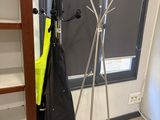 a coat rack that has two umbrellas on it