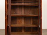 an antique wooden bookcase with a marble top and brass accents