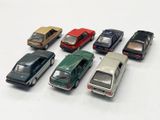 several toy cars are lined up in a row on a white surface