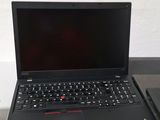 two laptops sitting on a table next to each other