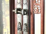a close up of a door handle on a wooden door