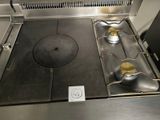 a metal stove top with two burners on it