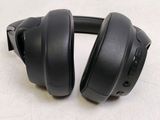 a pair of black headphones on a white surface