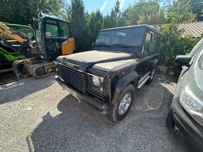 a black land rover parked in a lot next to other vehicles