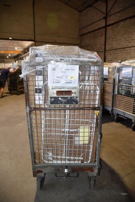 a large metal cart with a lot of items in it
