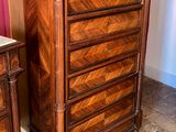 pair of antique wooden dressers with marble top in a room
