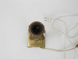 a camera that is connected to a cord on a table