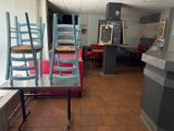 a room with several chairs and a table in it