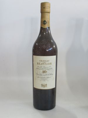 bottle of red wine on a white table with a glass of wine in the background