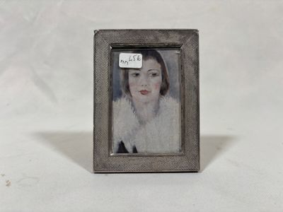 painting of a woman in a white fur coat in a silver frame