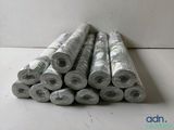 several rolls of paper sitting on top of each other on a table