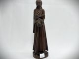 statue of a woman holding a cat on a white background