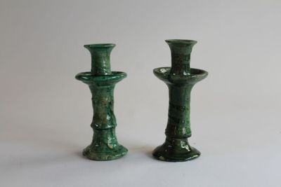 two green vases sitting next to each other on a table