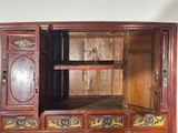 an old wooden cabinet with many drawers and doors