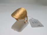 an image of a gold ring with a coin on it