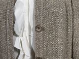 a mannequin wearing a jacket with a ruffle on it