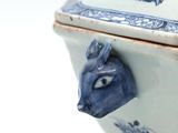 a blue and white bowl with a blue animal head on it