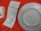 a white plate and a white plate on a red cloth