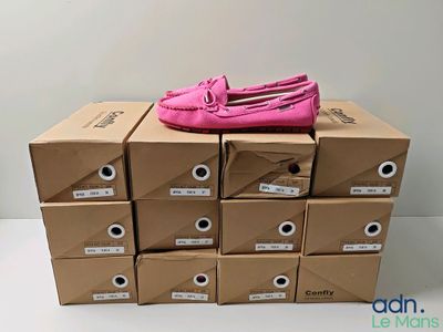 Plusieurs boîtes de chaussures roses sont empilées les unes sur les autres