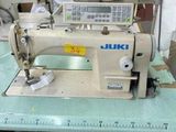 a sewing machine that is on a table in a room