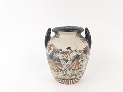 a vase with a painting on it sitting on a table