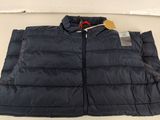 a close up of a jacket on a table with a tag on it