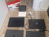 four laptops are sitting on the floor next to each other