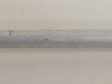 a close up of a metal pipe on a white wall