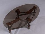 a glass table with a metal frame and a wooden base