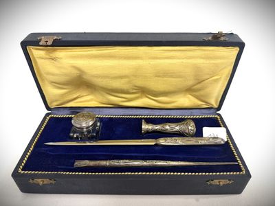 a silverware set in a black case on a white surface