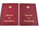 two red book covers with gold lettering on them sitting next to each other
