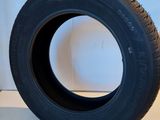 a close up of a tire on a white surface next to a wall