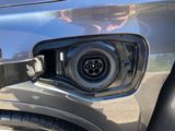 a close up of a car ' s front bumper with a plugged in