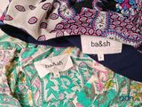 a pile of clothing with labels on them that say baksh