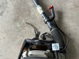 a close up of a blower sitting on the ground with a hose attached to it