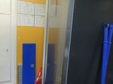 a black refrigerator and a blue door in a room