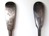two spoons that are sitting next to each other