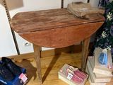 a small table with a wooden top on a hard wood floor