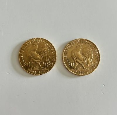 two gold coins, one of which is a rooster and the other of which is a bird