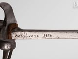 a close up of a metal object with a hammer on it