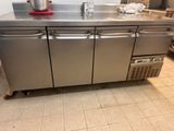 a stainless steel counter with a red bowl on top of it